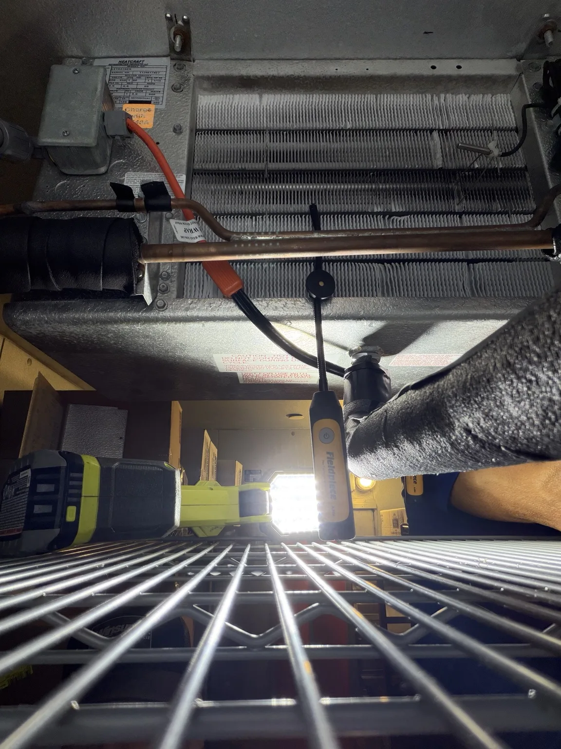 Temperature probe positioned near a walk-in freezer evaporator during pull-down testing