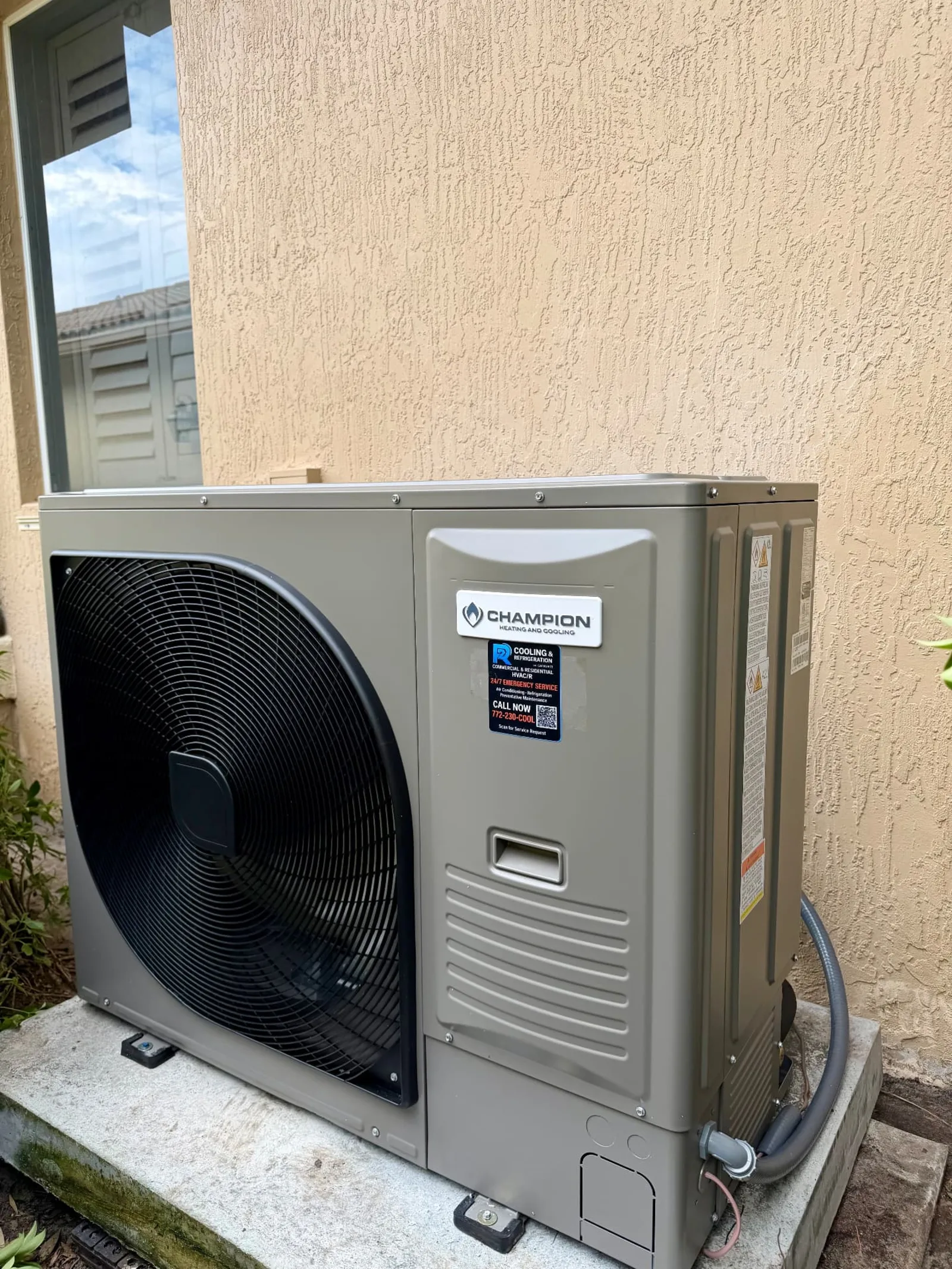 Champion HH8 inverter heat-pump outdoor unit installed on a concrete pad at a Port St. Lucie, Florida home by 2R Cooling