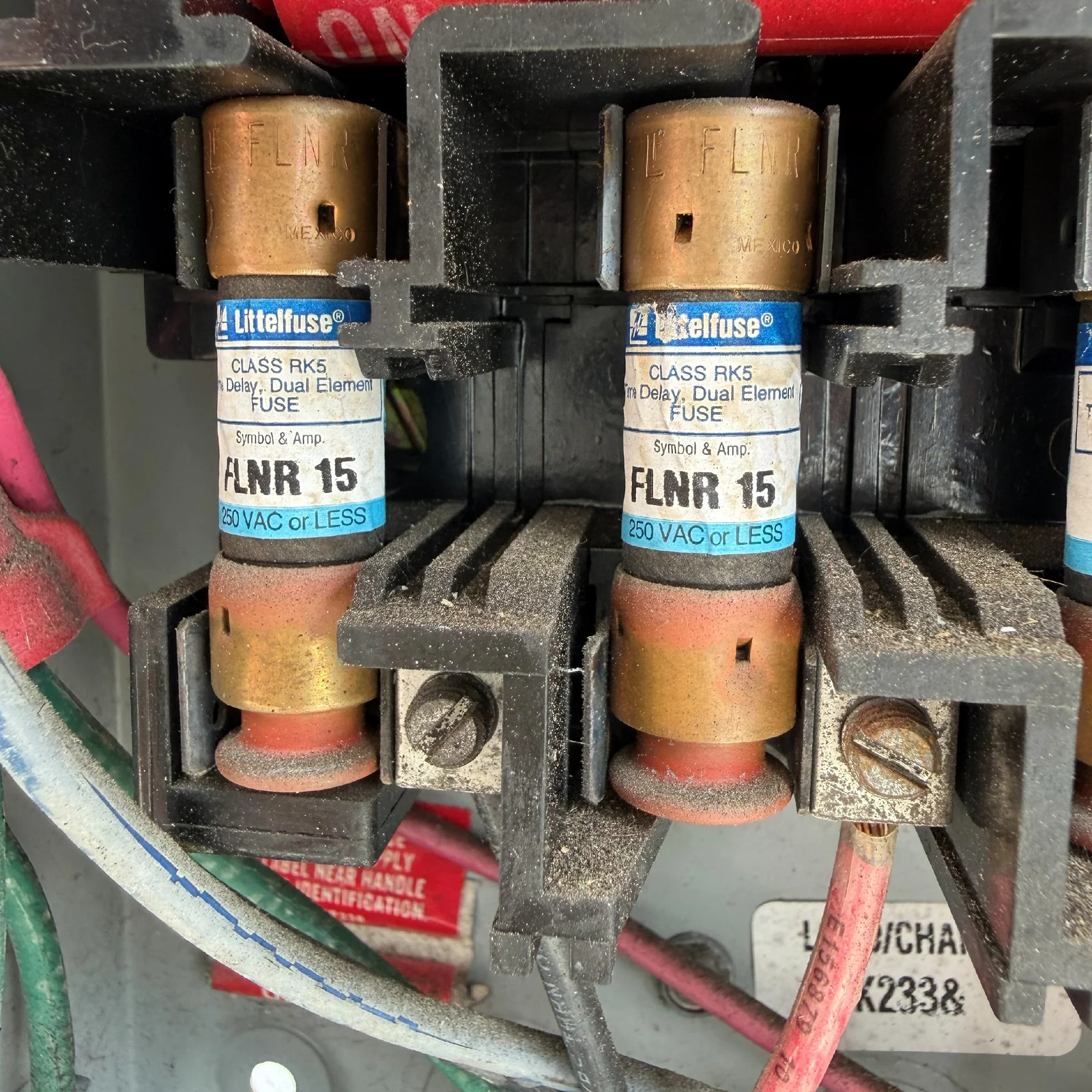 Two 15-amp time-delay fuses inspected during Jensen Beach walk-in freezer repair