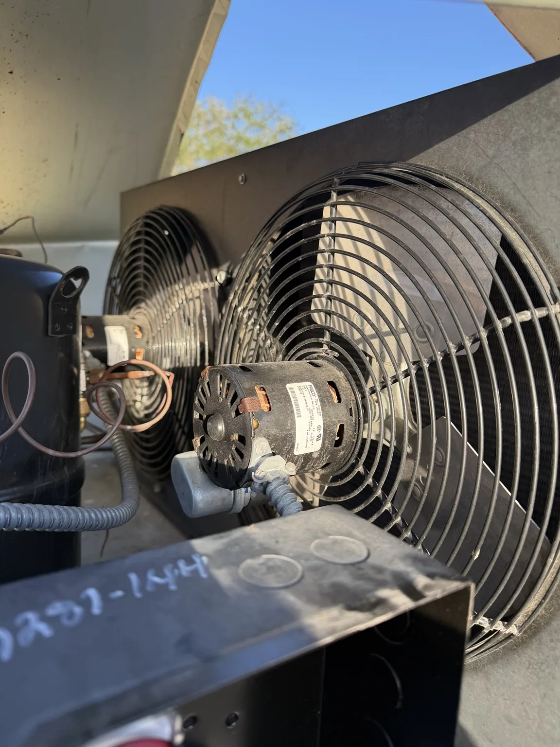Condenser fan motor and fan guard on the walk-in freezer condensing unit in West Palm Beach
