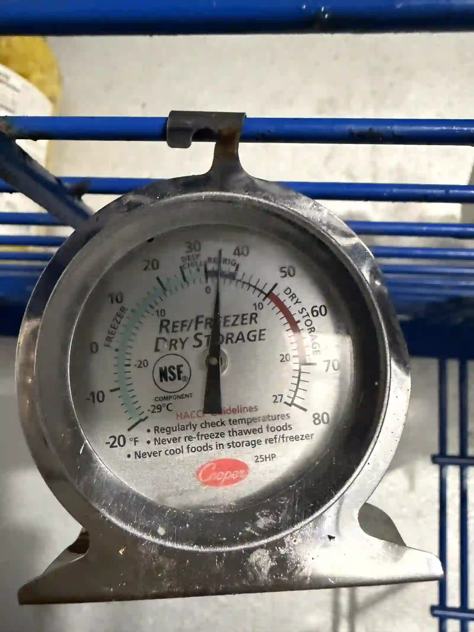 NSF refrigerator thermometer inside the repaired walk-in cooler at Alfonso's Pizza reading in the safe refrigeration range after the Tecumseh condensing unit replacement