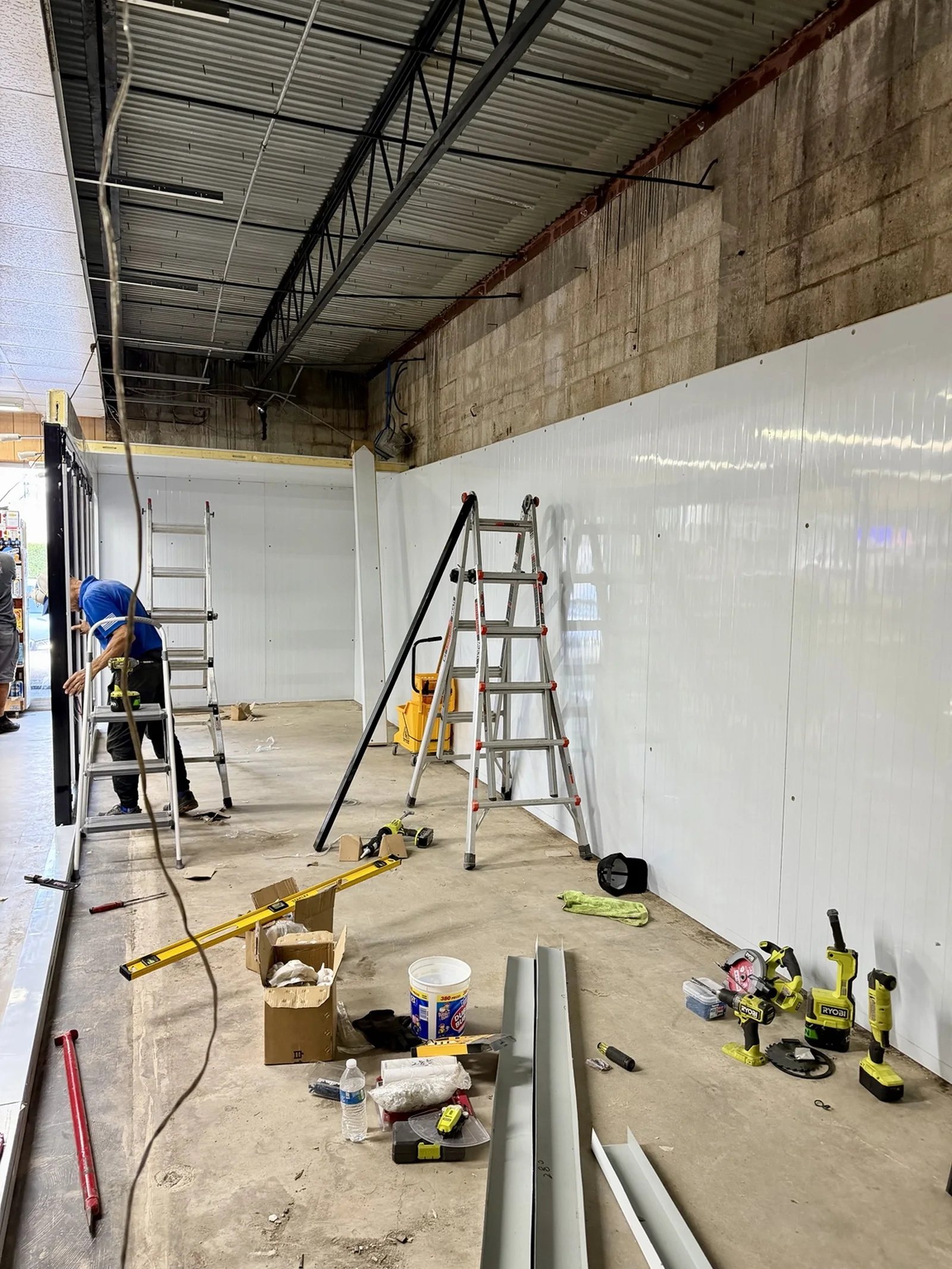 Replacement walk-in cooler wall panels during assembly
