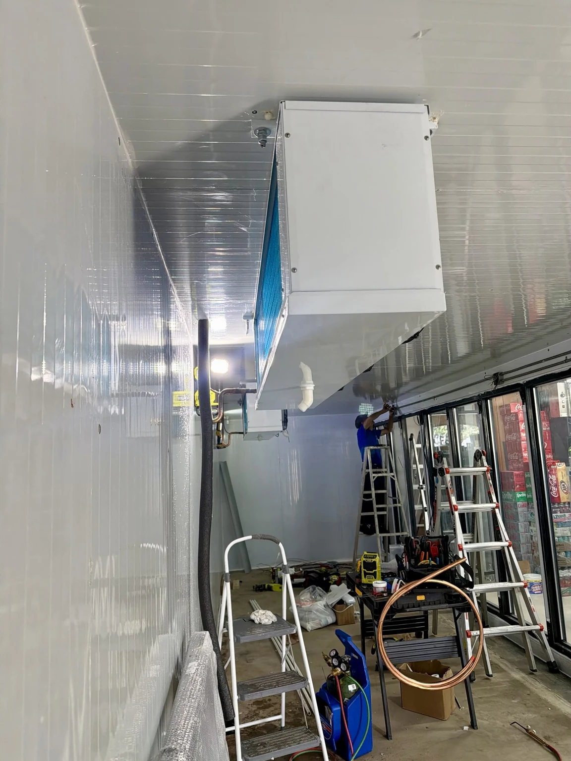 Evaporators and copper piping inside the Tequesta walk-in cooler during installation