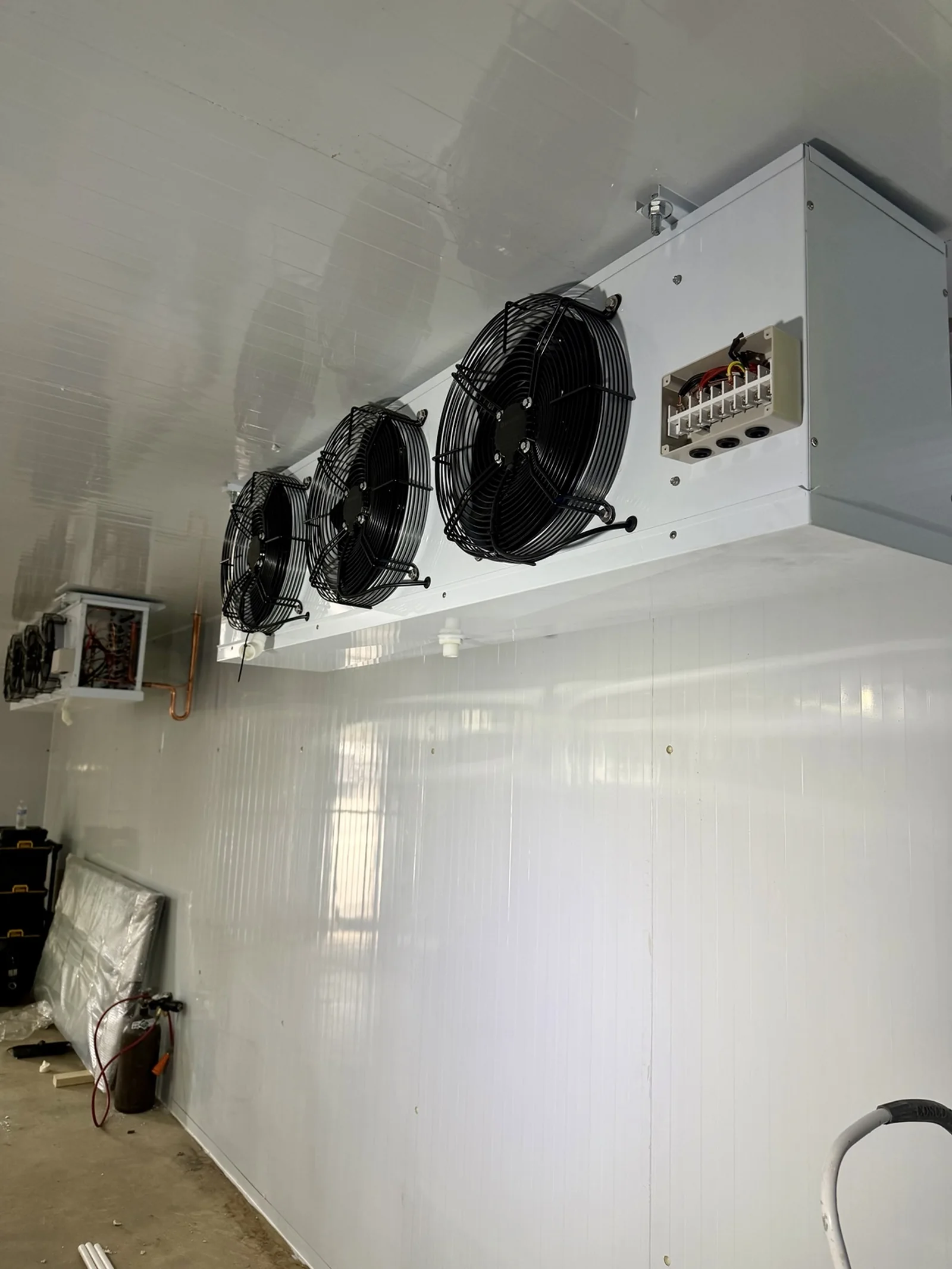 Two ceiling-mounted evaporators inside the Tequesta walk-in cooler during installation